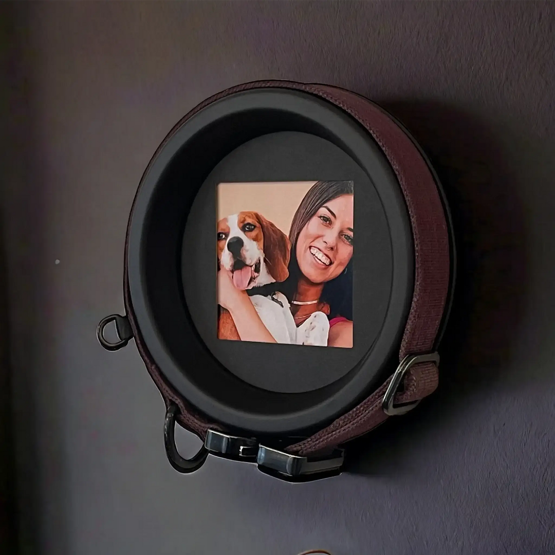 Wall-mounted beagle pet memorial frame with dark purple collar and photo of a woman holding her dog.
