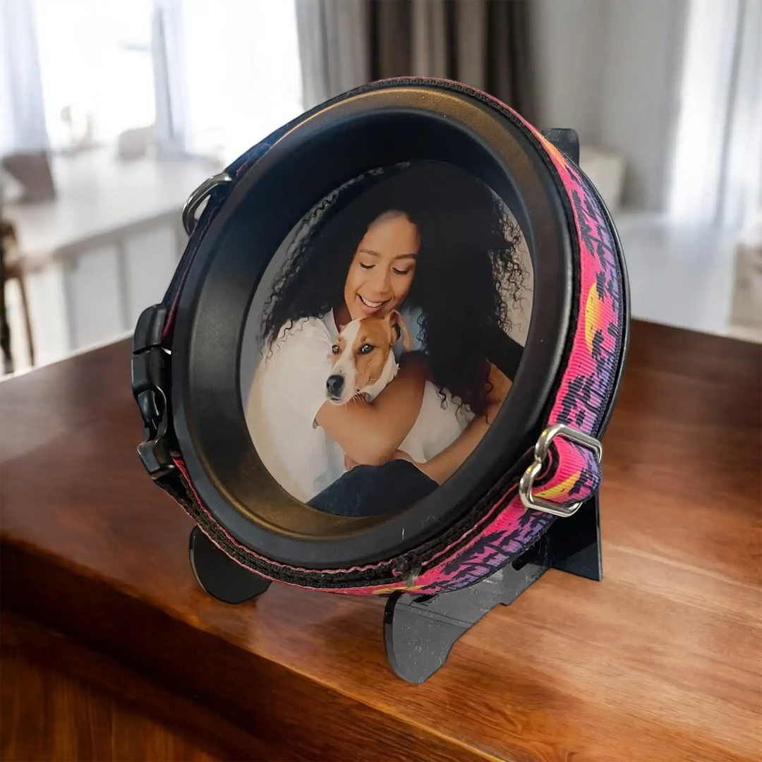 Pet memorial frame with patterned collar featuring a woman hugging her dog, displayed on a table by Whisker & Fang.