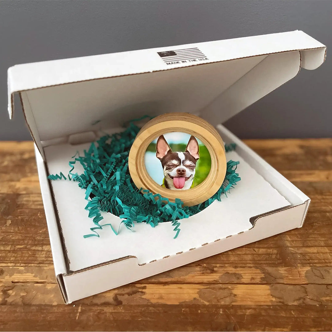 Chihuahua pet memorial frame with photo and wooden border, packed inside a Whisker & Fang shipping box with crinkle paper.