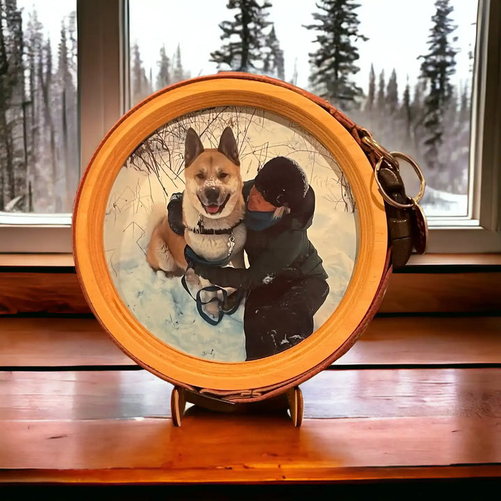 XL Halo Frame from Whisker & Fang with natural wood frame and Akita photo, shown on a windowsill with a snowy forest background.