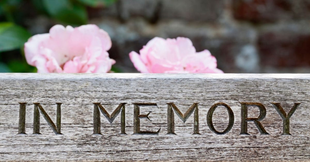 Pet memorial display featuring a dog photo, collar, flowers, and keepsakes