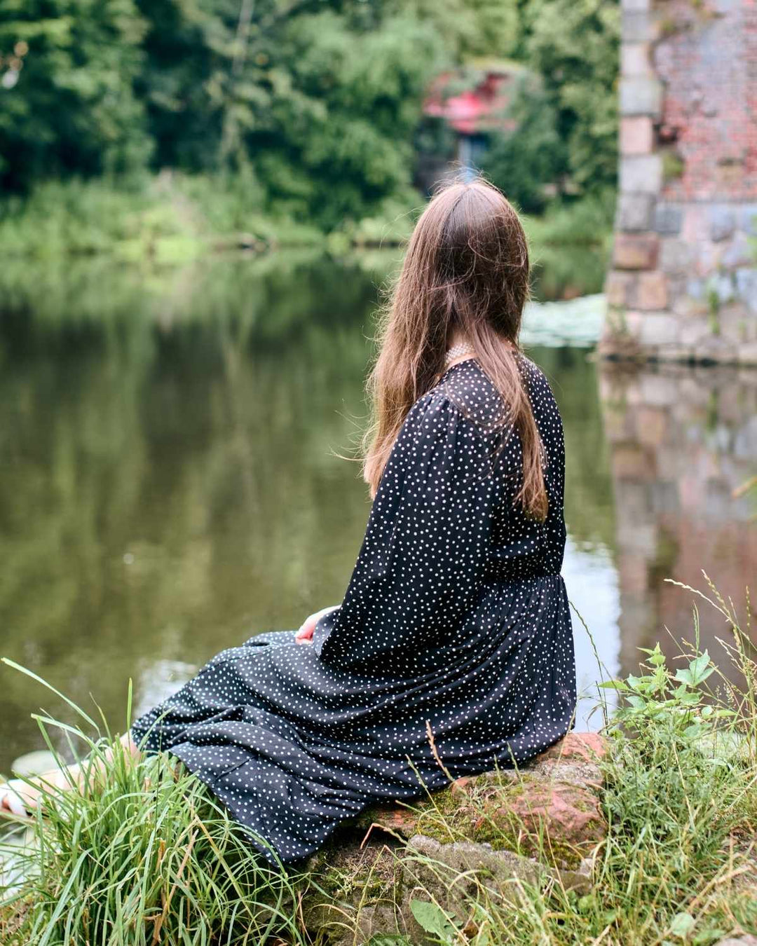 Person sitting quietly at home reflecting on the grief and emotional impact of losing a beloved dog