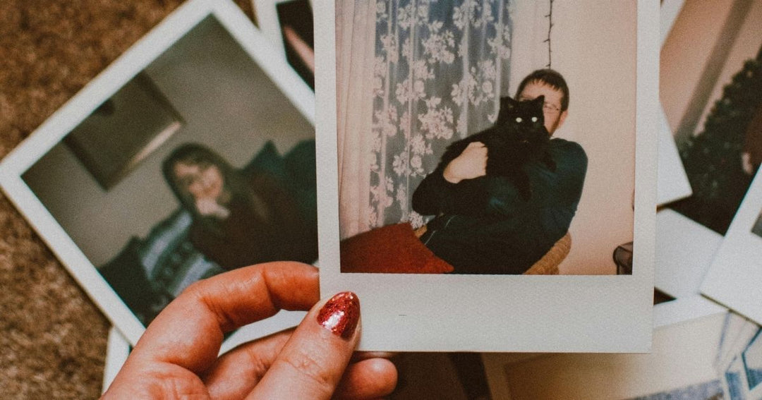 Pet owner grieving the loss of a beloved dog while looking at a cherished photograph.
