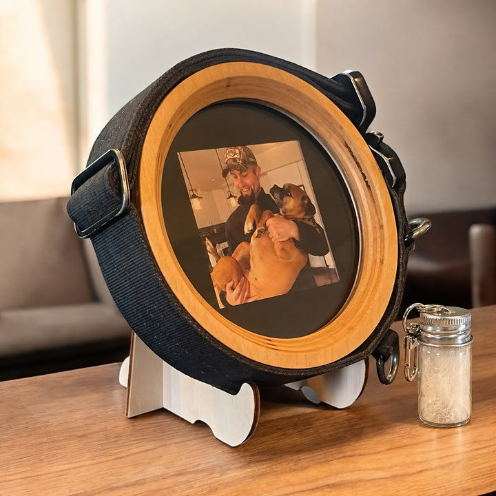 medium extra wide wood dog collar display frame and fur keepsake capsule sitting on top of a light wood table