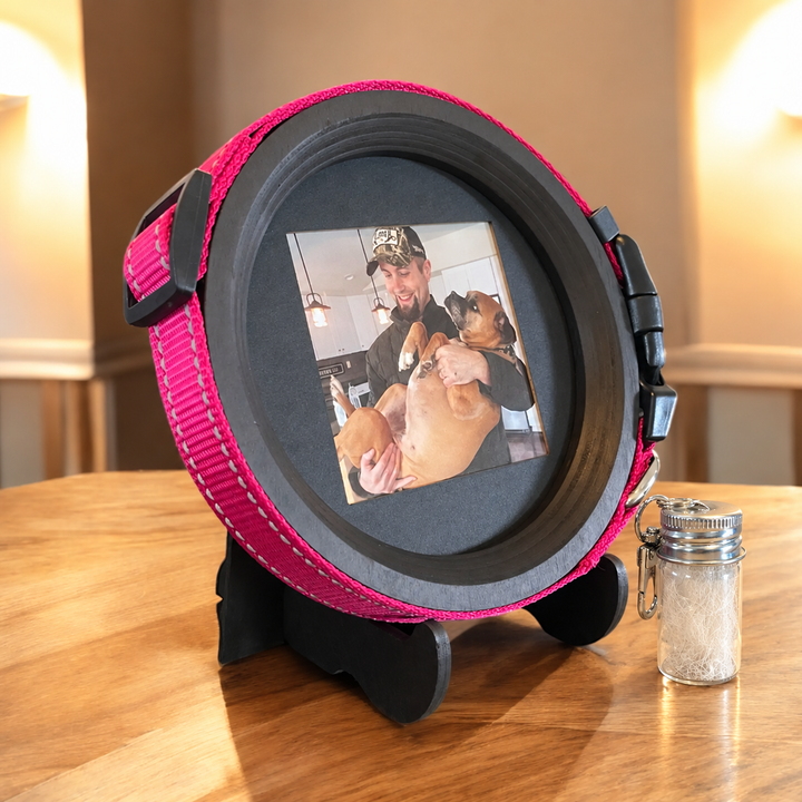 medium black wood dog collar display frame and fur keepsake capsule on light colored wood table top