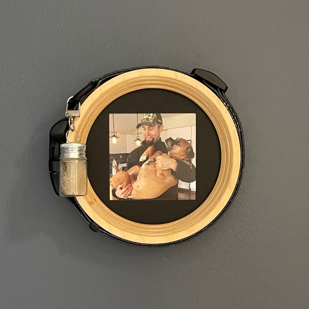 medium extra wide dog collar wooden picture frame with fur keepsake capsule on a dark wall